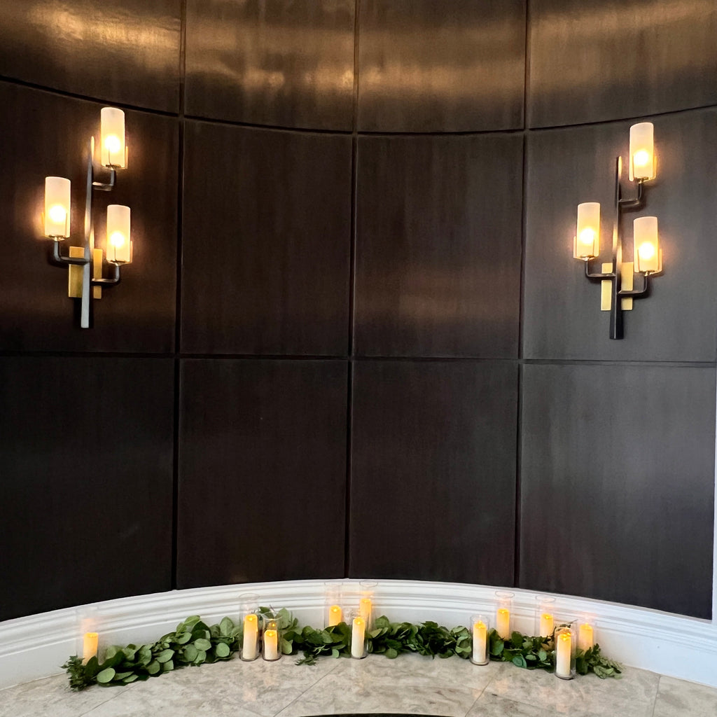 Dark tiled floor with wall-mounted lights and decorative elements.