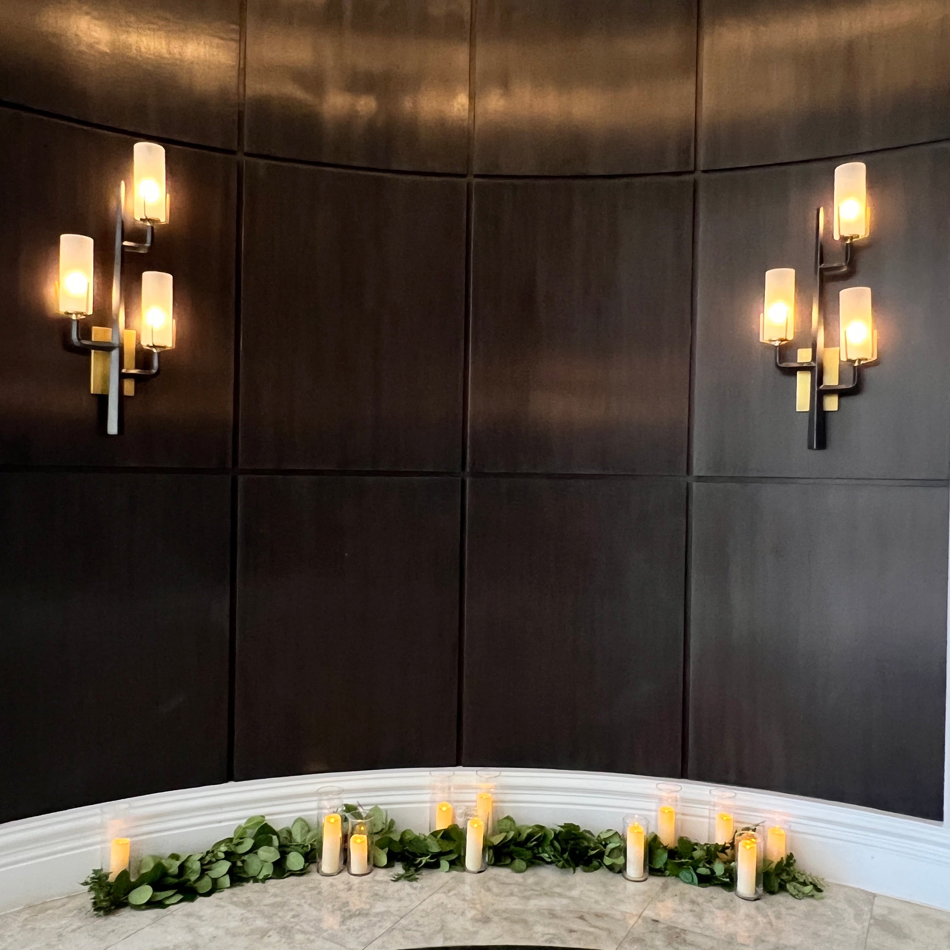 Dark tiled floor with wall-mounted lights and decorative elements.