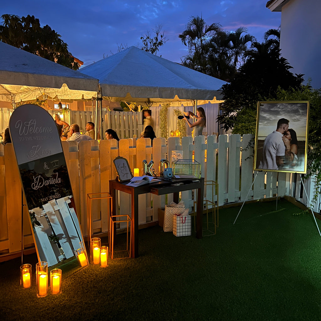 Outdoor patio area with tables, chairs, and string lights at dusk.