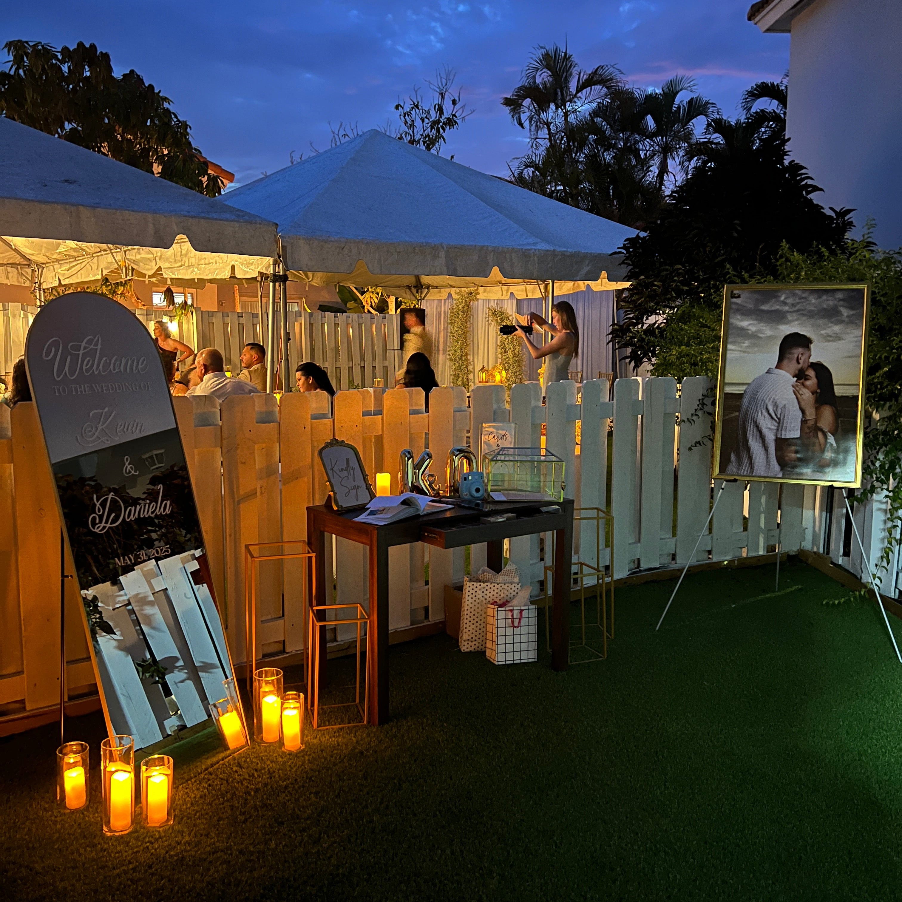 Outdoor patio area with tables, chairs, and string lights at dusk.