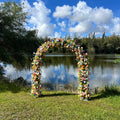 Colorful flower wreath on a wall with a blue sky and clouds in the background