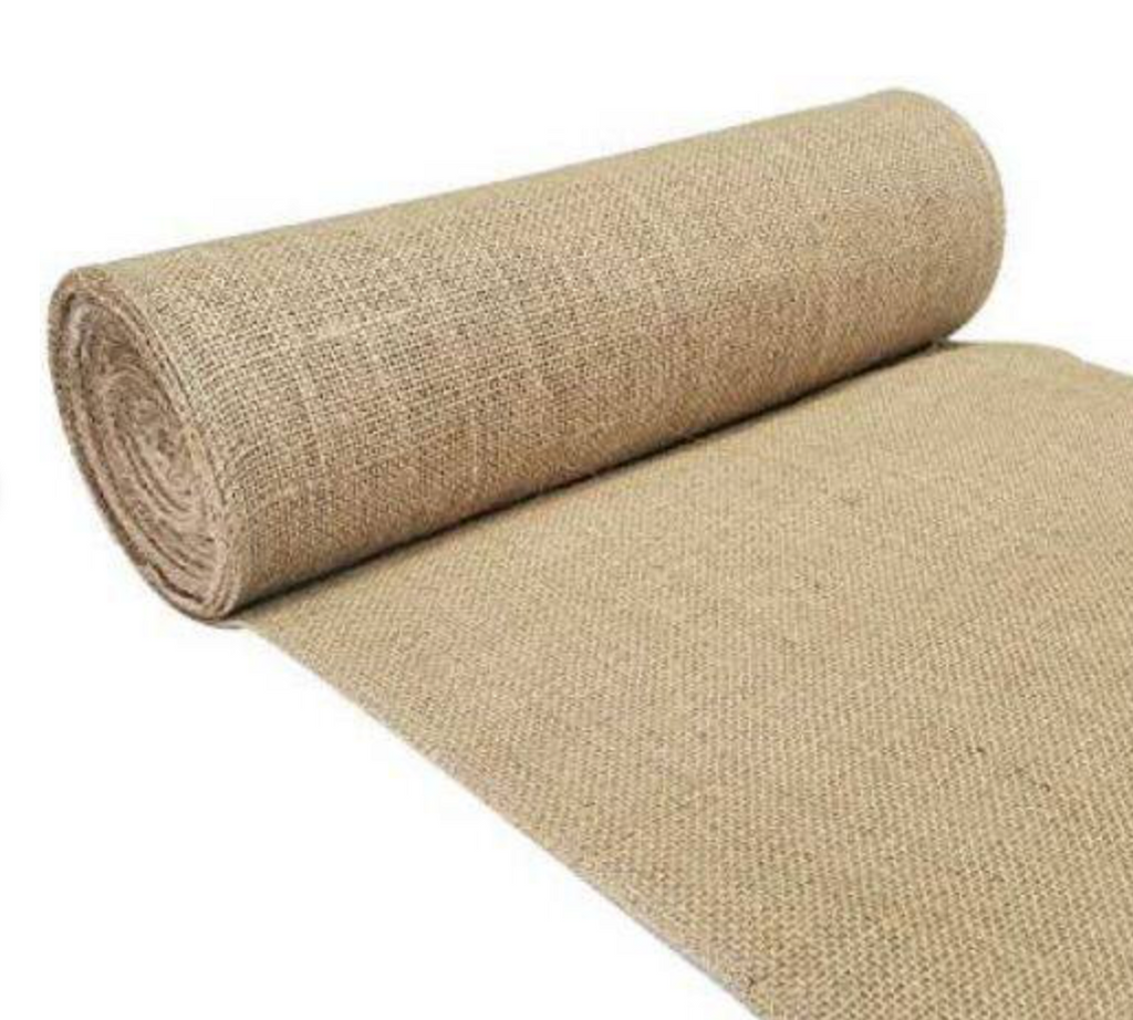 Rolled-up beige jute rug on a white background